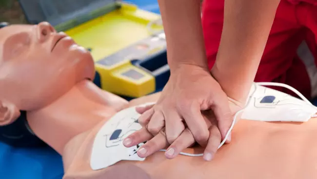 Person practicing CPR on a mannequin